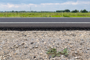 Asphalt on rocks and cloudy skies.