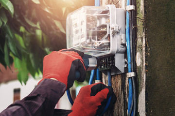 electrician installing watthour meter at home