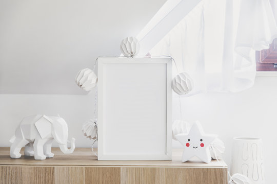 The modern sandinavian newborn baby room with mock up poster frame, cotton lamps and star. Sunny and bright interior.