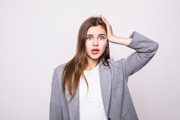 Young woman in confusion isolated on white background