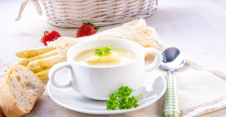 asparagus cream soup with capers and fresh baguette
