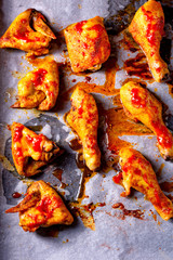 Rustic backed chicken wings,legs on baking tray
