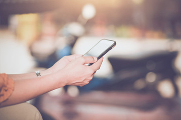 Woman typing text message on smart phone