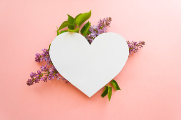 Heart frame with blossom lilac on pink background