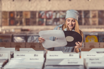 Smiling girl in a vinyl record store