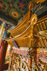 Golden Korean ornament decorated inside Yakcheonsa Temple. Jeju, South Korea.