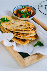 Homemade indian naan with topping from fresh carrots and coriander.