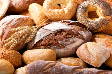 various types of fresh bread with wheat ears