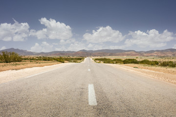 alone empty asphalt road with clouds in Morocco