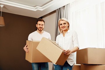 Moving House. Man And Woman Holding Boxes
