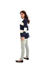 full length portrait of girl wearing striped blue and white jumper and jeans. standing pose  facing away from the camera, on white studio background