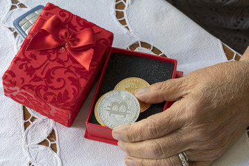 Gift box and Hands Holding Digital Money Bitcoin