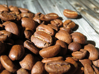 Roasted coffee beans on a wooden table, selective focus