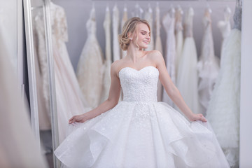 Fototapeta premium Attractive young girl in wedding dress