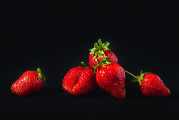 ripe strawberries on a black background