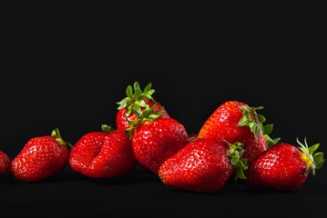 ripe strawberries on a black background