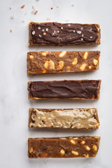 Various of raw vegan homemade chocolate peanut candy bars, top view.  Healthy lifestyle and raw vegan food concept.