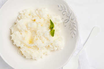 Rice milk porridge for breakfast. White background, top view, copy space.