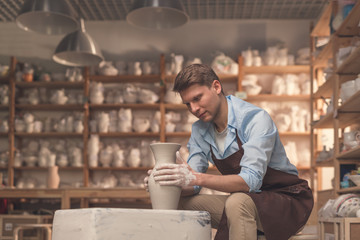 Young man at the potter's wheel