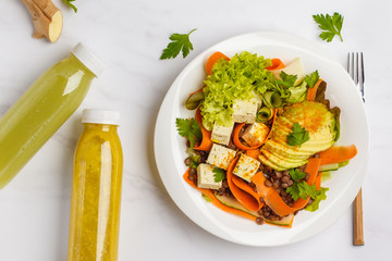 Flat lay of vegan vegetables salad with lentils, avocado and smoothie (juice) in the bottle. Healthy vegan food concept.
