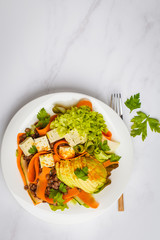 Vegan vegetables salad with lentils, avocado and tofu. Healthy vegan food concept.