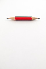 A small pencil, shap at both ends, on a white background
