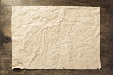 wrinkled paper at wooden  background