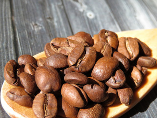 Wooden spoon with coffee beans, macro shot