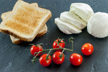 cherry tomatoes mozzarella toast on slate breakfast concept