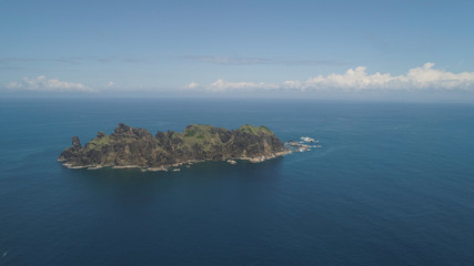 Small rocky islands in the sea, blue sky and clouds. Dos Hermanas, Palau, Santa Ana. Aerial view of seascape with tropical islands in the ocean.