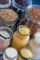 Rice (white and black), millet, oatmeal (ground and in grains), couscous, buckwheat, semolina in teklyannoy dishes, selective focus