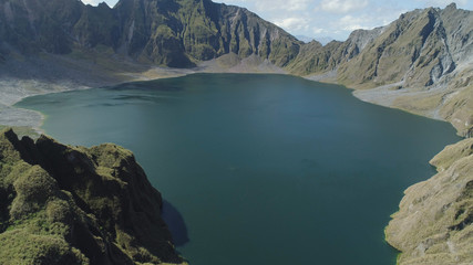 Fototapeta na wymiar Crater lake of the volcano Pinatubo among the mountains, Philippines, Luzon. Aerial view beautiful landscape at Pinatubo mountain crater lake. Travel concept