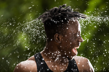 Man sprinkles water turning his face