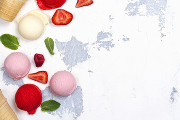 Orange, vanilla, raspberry and strawberry ice cream scoops on white background