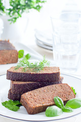 Delicate pate-casserole from chicken liver on a white plate, selective focus