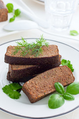 Delicate pate-casserole from chicken liver on a white plate, selective focus
