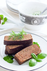 Delicate pate-casserole from chicken liver on a white plate, selective focus