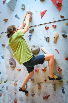 Teenage Boy Training On Climbing Wall