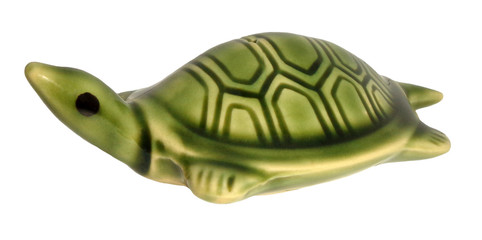 Green turtle ceramic figurine isolated on white background