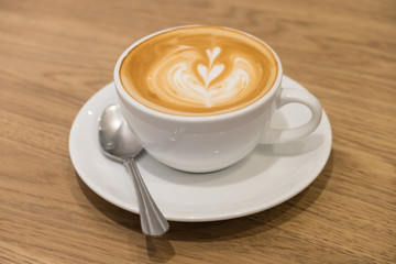 Latte coffee on the wood table.