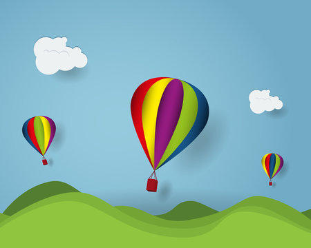 hot air balloon cartoon flying over green hill