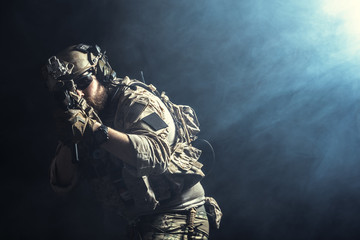 Fototapeta premium Special forces soldier with rifle on dark background