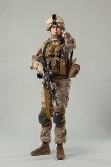 Soldier in camouflage holding rifle