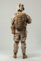 Soldier in camouflage holding rifle