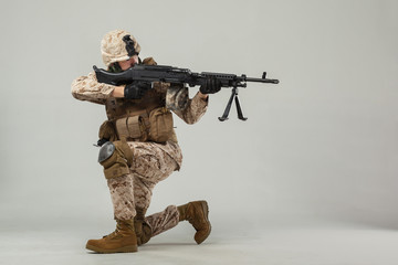 Soldier in camouflage holding rifle