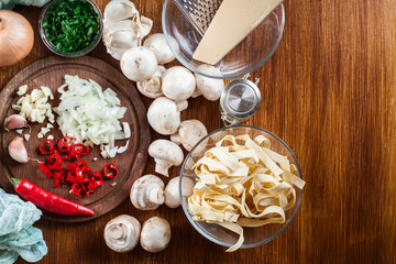 Ingredients ready for prepare tagliatelle pasta with champignon