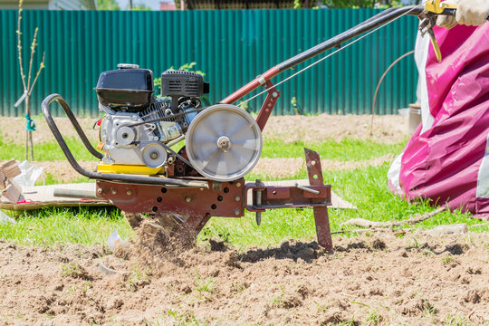 close up of a tractor (motoblock)  plowing the field
