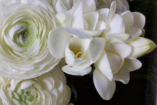 details of a wedding bouquet with white buttercups and white fresia