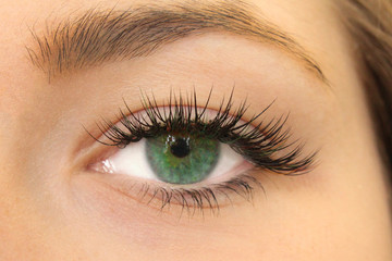 Fototapeta premium Beautiful Woman with long lashes in a beauty salon. Eyelash extension.