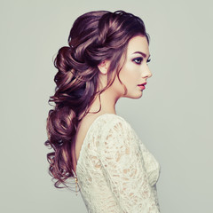 Brunette woman with long and shiny curly hair